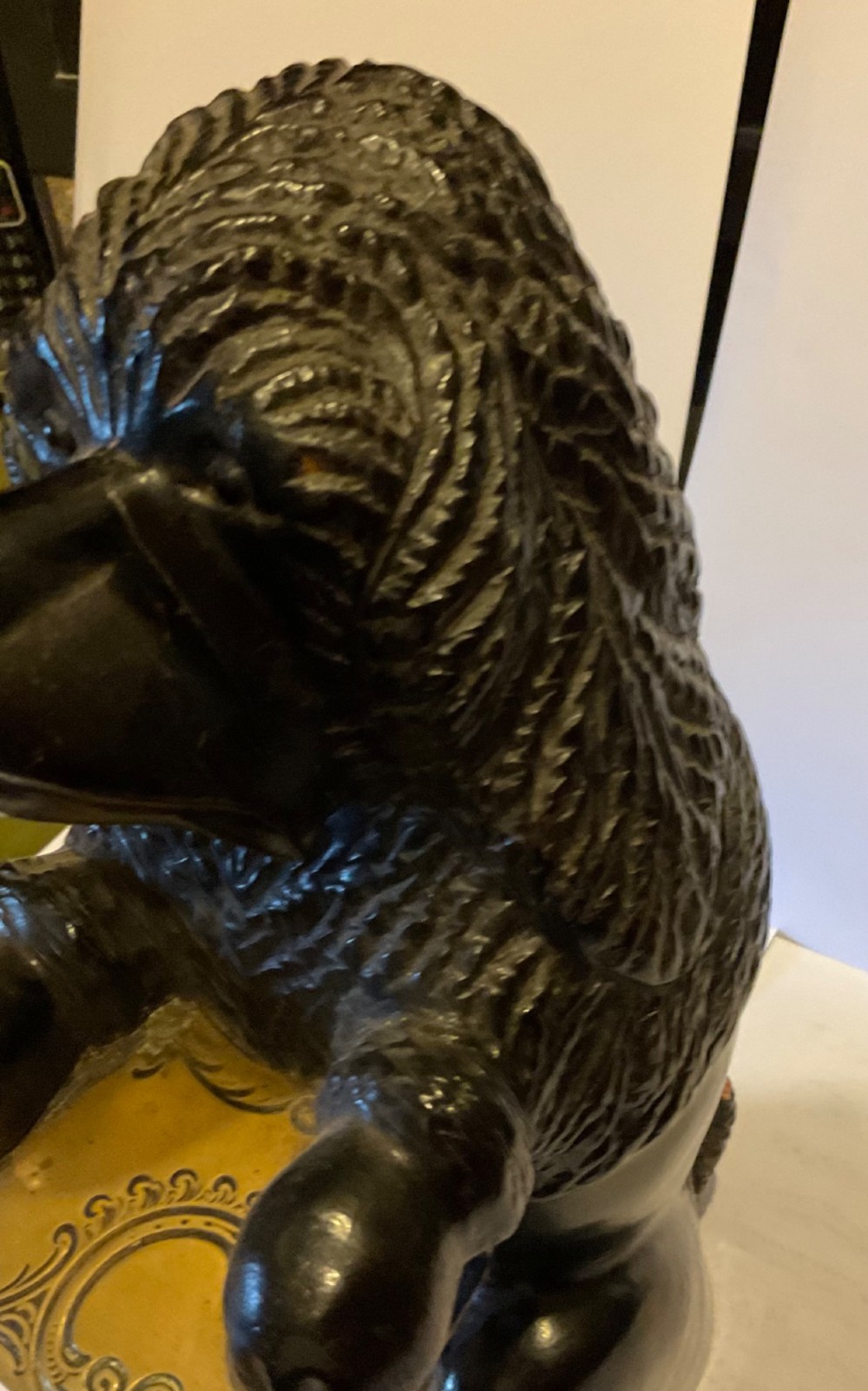 A nineteenth-century carved dark wood match dispenser styled as a begging dog with textured fur and a decorated brass base plate. View V