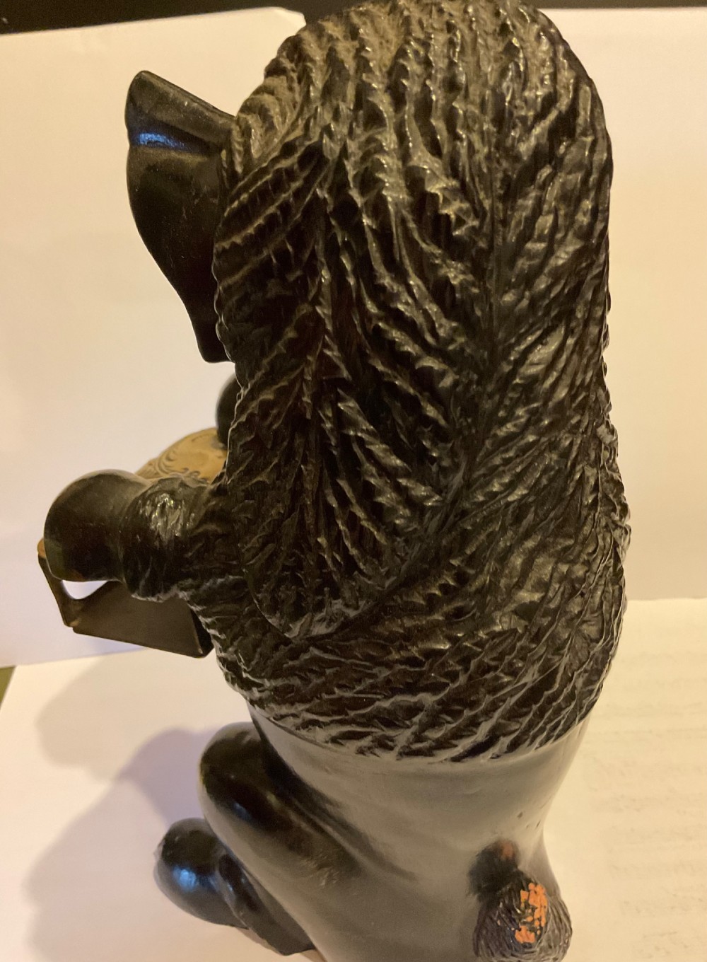 A nineteenth-century carved dark wood match dispenser styled as a begging dog with textured fur and a decorated brass base plate. View VII