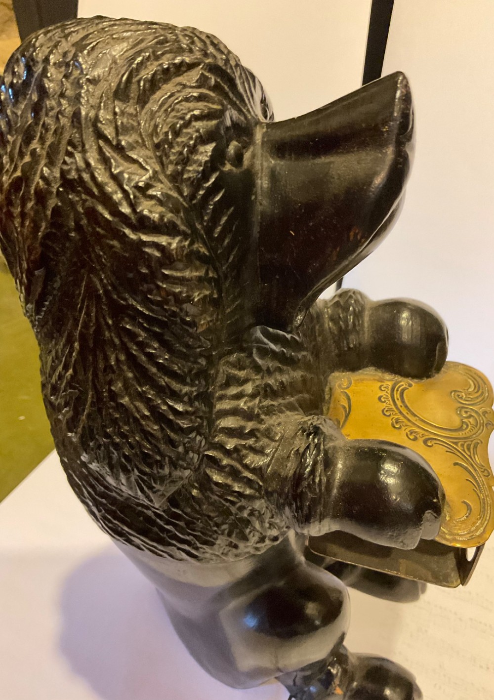 A nineteenth-century carved dark wood match dispenser styled as a begging dog with textured fur and a decorated brass base plate. View IX