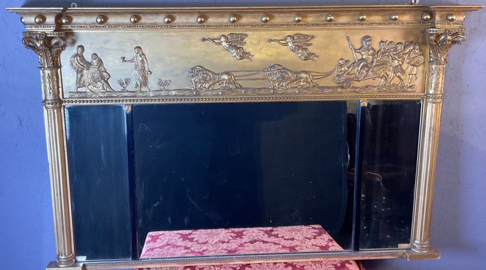 A Victorian gilded gesso overmantel mirror featuring a classical relief frieze above three mirror plates framed by fluted Corinthian columns. View II