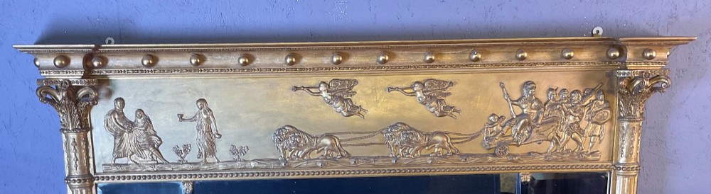 A Victorian gilded gesso overmantel mirror featuring a classical relief frieze above three mirror plates framed by fluted Corinthian columns. View III