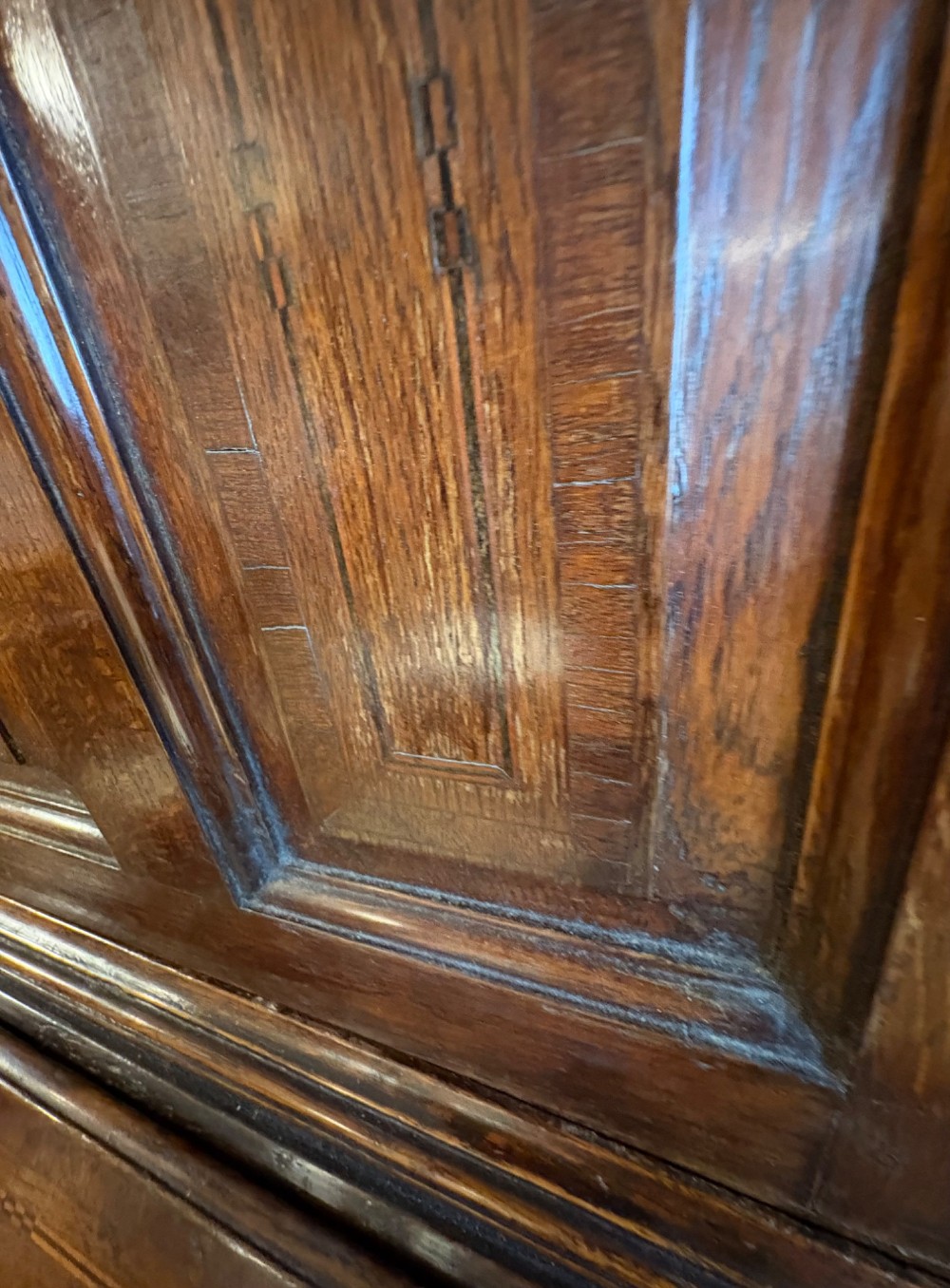 An 18th-century dark oak bureau bookcase featuring an upper cabinet with double panelled doors above a slant-front writing desk and lower drawers with brass handles. View XII