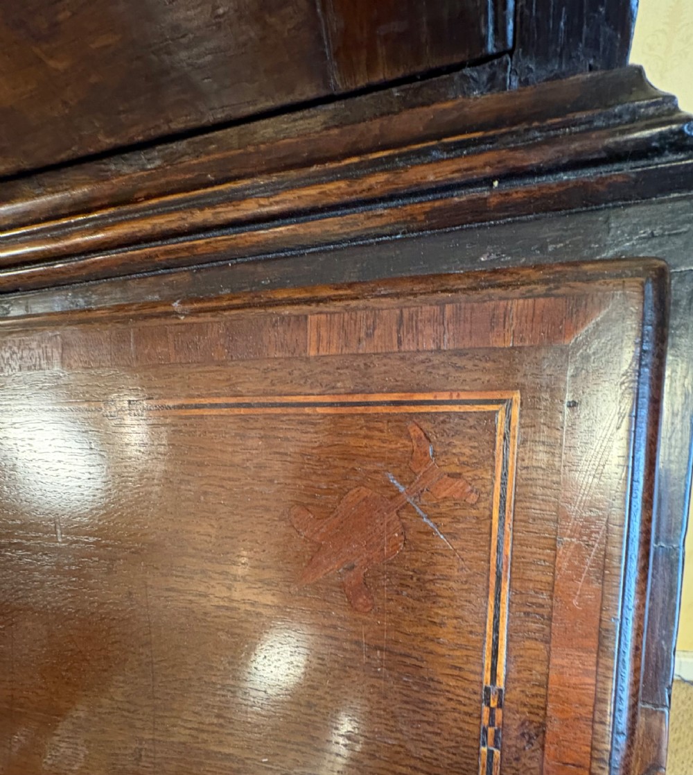 An 18th-century dark oak bureau bookcase featuring an upper cabinet with double panelled doors above a slant-front writing desk and lower drawers with brass handles. View XIV