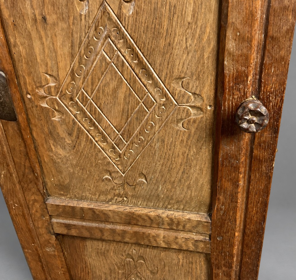 A pair of hand-adzed solid oak cabinet doors featuring three recessed panels with carved diamond motifs and iron strap hinges. View IV