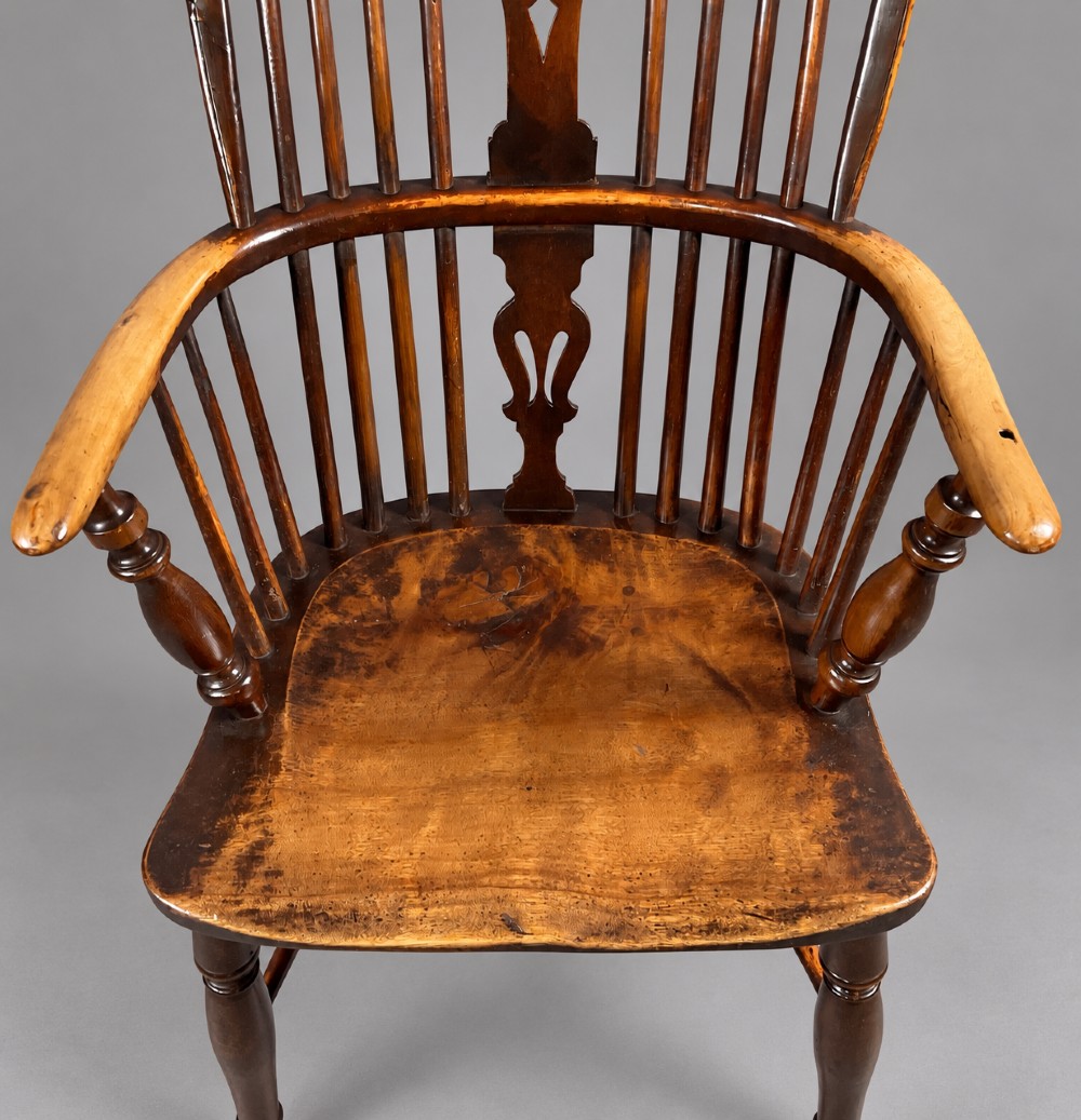 A nineteenth-century high-back yew wood Windsor armchair featuring a pierced back splat, spindled hoop back, shaped elm seat, turned legs, and a crinoline stretcher. View IV