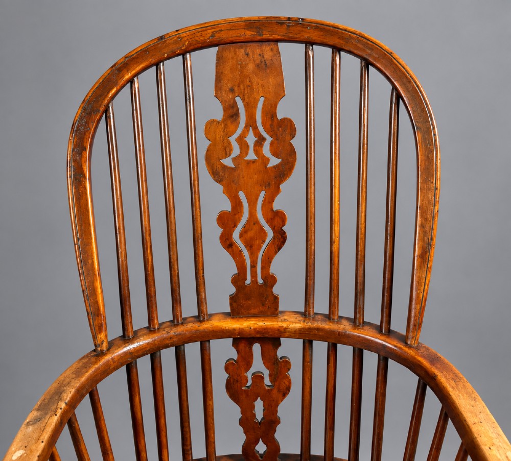 An antique high-back yew wood Windsor armchair featuring turned legs, a shaped seat, and a central pierced fretwork splat. View II