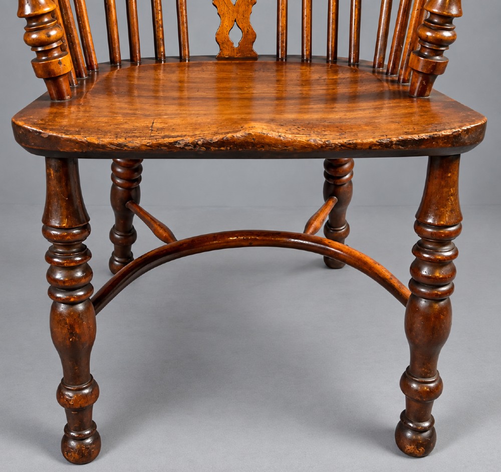 An antique high-back yew wood Windsor armchair featuring turned legs, a shaped seat, and a central pierced fretwork splat. View III