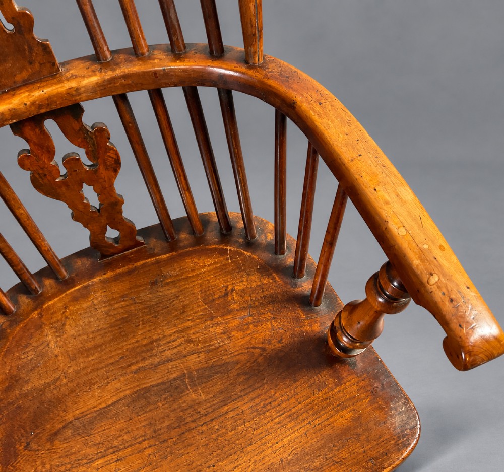 An antique high-back yew wood Windsor armchair featuring turned legs, a shaped seat, and a central pierced fretwork splat. View IV