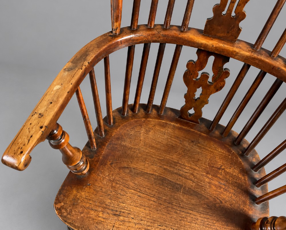 An antique high-back yew wood Windsor armchair featuring turned legs, a shaped seat, and a central pierced fretwork splat. View VII