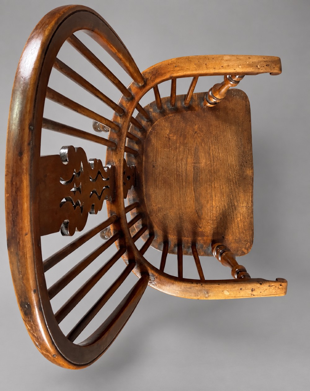 An antique high-back yew wood Windsor armchair featuring turned legs, a shaped seat, and a central pierced fretwork splat. View VIII