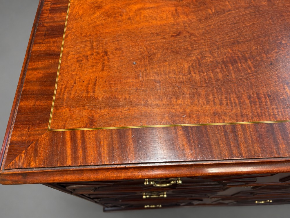 An 18th-century mahogany chest of drawers featuring geometric mitred mouldings, cast brass swan-neck handles, keyhole escutcheons, and bracket feet. View III