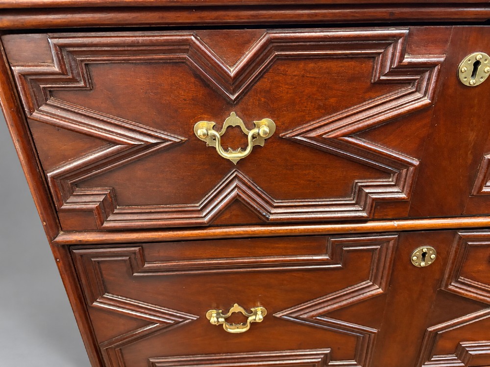 An 18th-century mahogany chest of drawers featuring geometric mitred mouldings, cast brass swan-neck handles, keyhole escutcheons, and bracket feet. View VIII