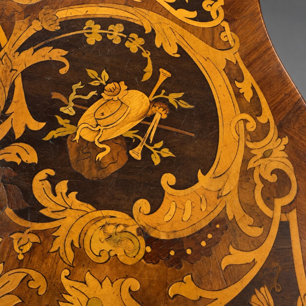 A French Rococo Revival marquetry games table featuring elaborate floral and bird inlay, cast brass mounts, and cabriole legs. View VI