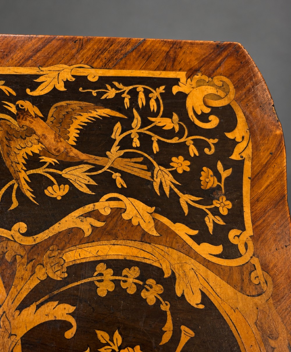 A French Rococo Revival marquetry games table featuring elaborate floral and bird inlay, cast brass mounts, and cabriole legs. View VII