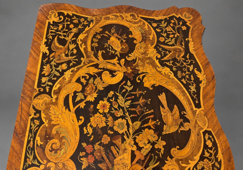 A French Rococo Revival marquetry games table featuring elaborate floral and bird inlay, cast brass mounts, and cabriole legs. View VIII