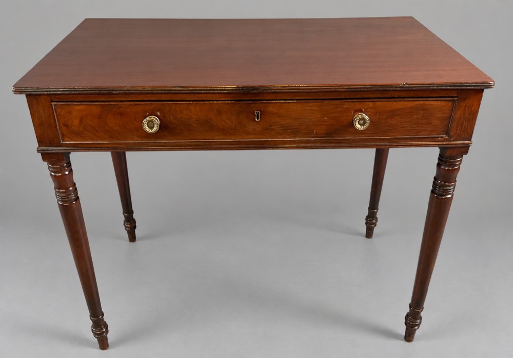 A rectangular mahogany library table featuring a single frieze drawer with brass handles and turned tapered legs. View VI