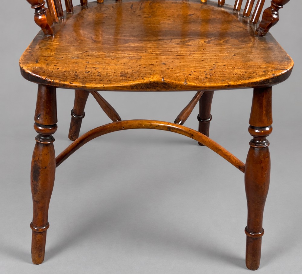 A low back antique yew wood Windsor chair featuring a contoured seat, turned legs, a crinoline stretcher, and a pierced decorative splat. View II