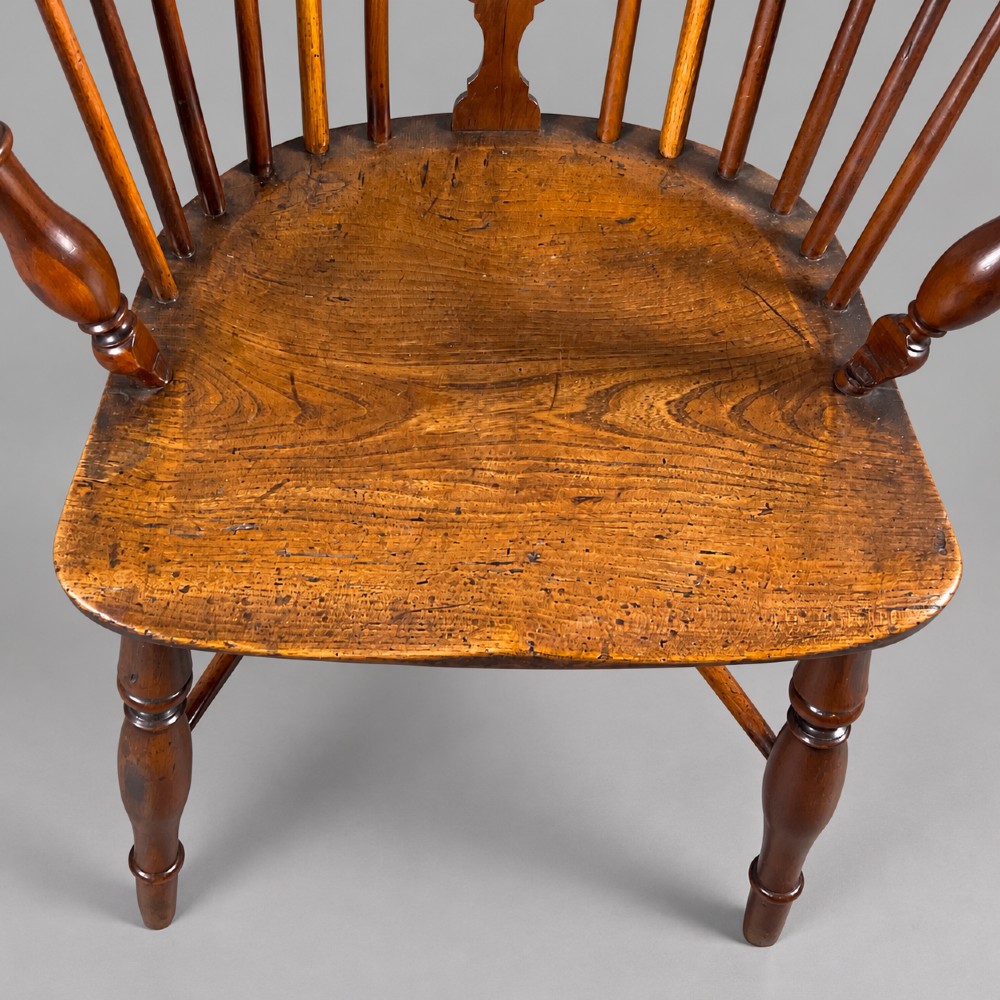 A low back antique yew wood Windsor chair featuring a contoured seat, turned legs, a crinoline stretcher, and a pierced decorative splat. View III