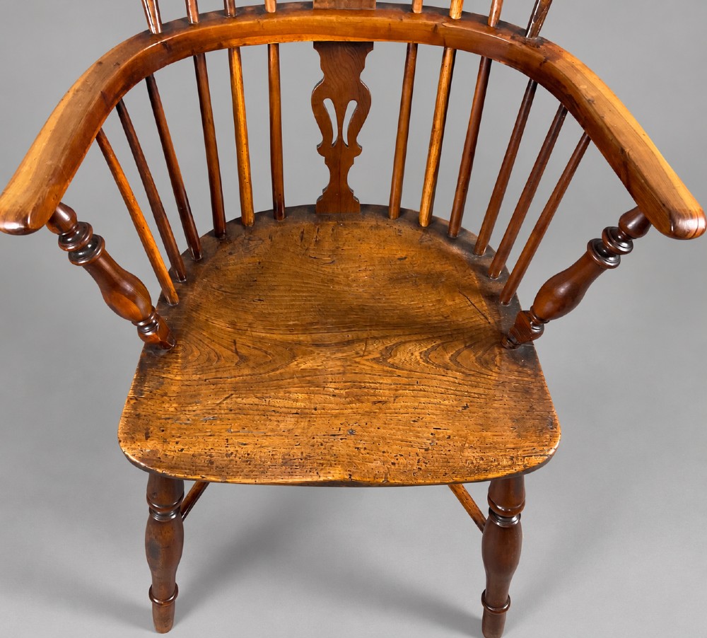 A low back antique yew wood Windsor chair featuring a contoured seat, turned legs, a crinoline stretcher, and a pierced decorative splat. View IV
