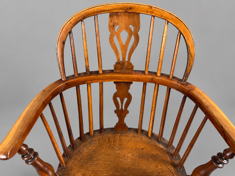 A low back antique yew wood Windsor chair featuring a contoured seat, turned legs, a crinoline stretcher, and a pierced decorative splat. View VII