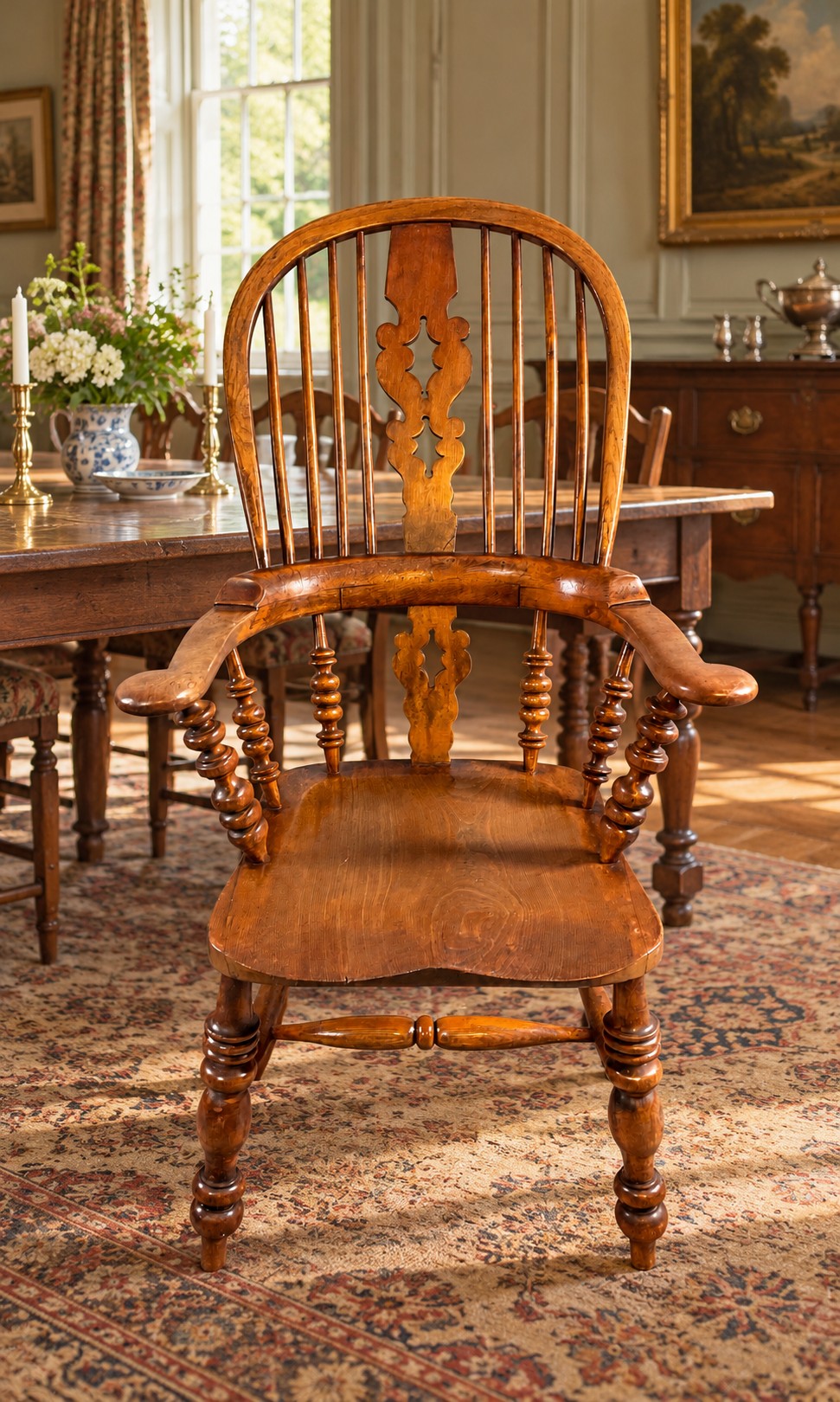 An antique Victorian wooden Windsor armchair featuring a hoop back, a central pierced splat, broad curved armrests, a shaped saddle seat, and turned legs. View VIII