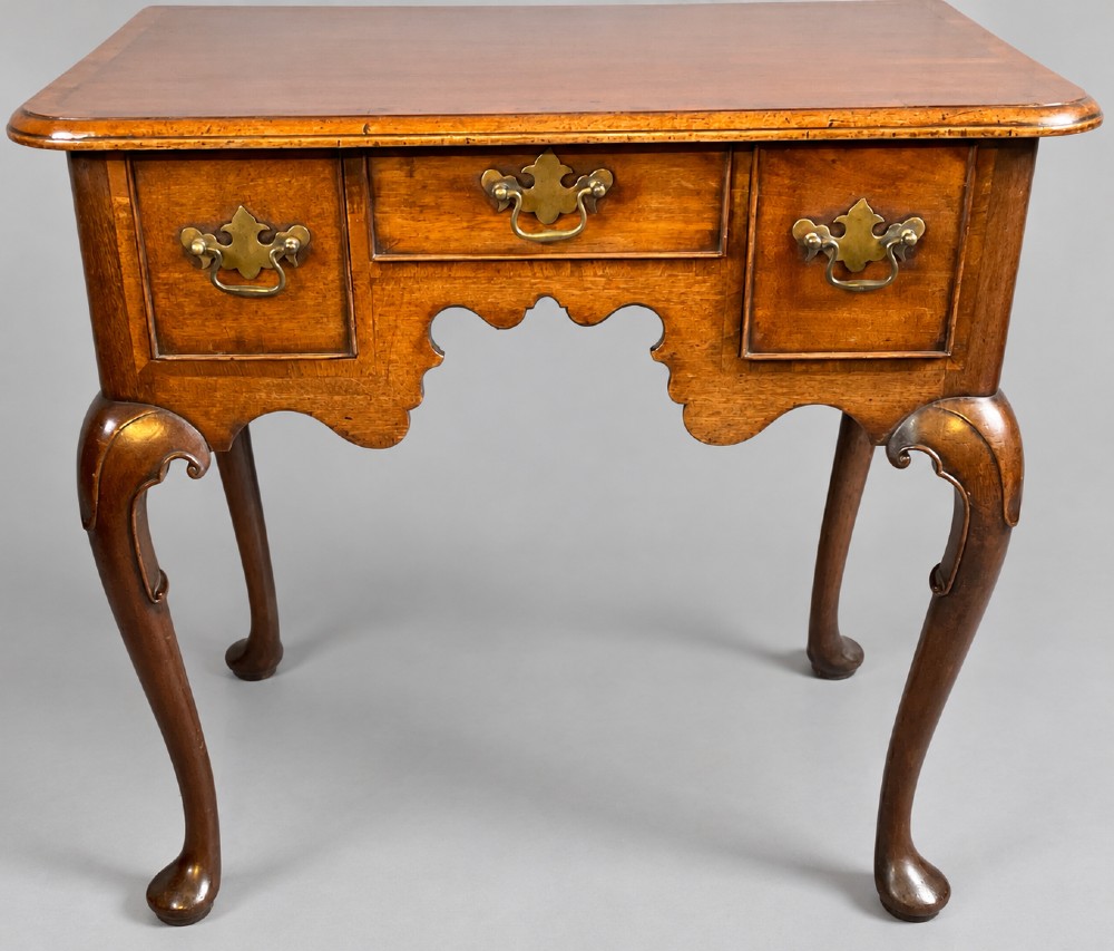 An 18th-century mahogany lowboy featuring three brass-handled drawers, a shaped apron, and four cabriole legs ending in pad feet. View III
