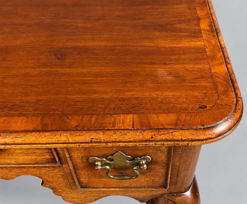An 18th-century mahogany lowboy featuring three brass-handled drawers, a shaped apron, and four cabriole legs ending in pad feet. View XII