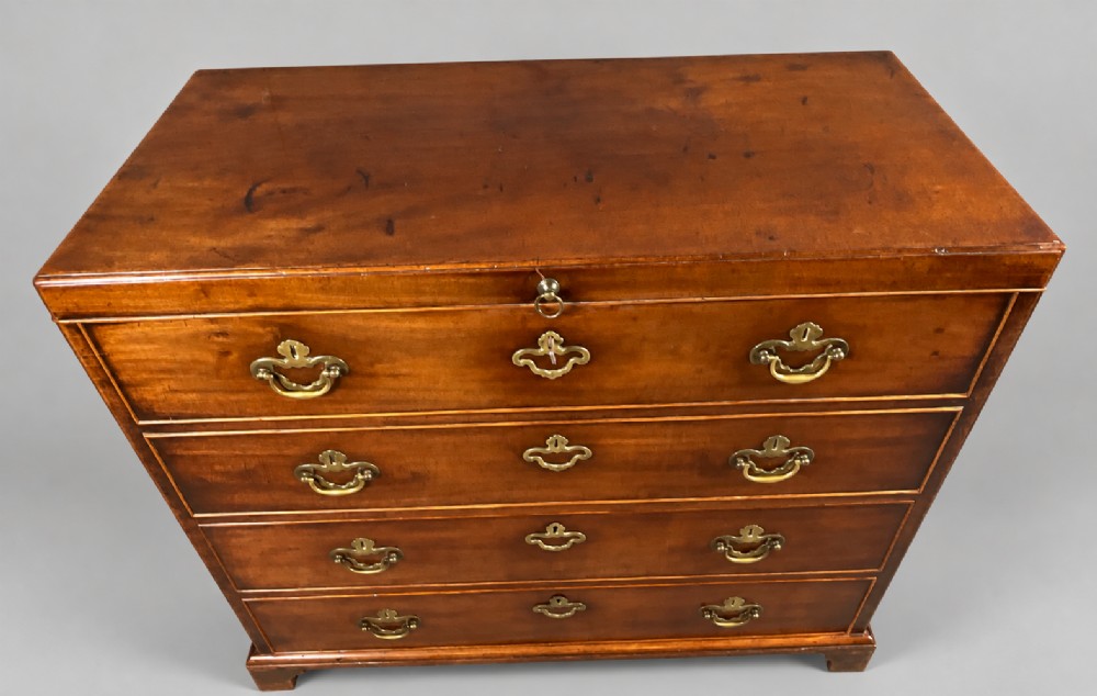 An 18th-century mahogany campaign dressing chest featuring graduated drawers with brass bail handles, side carrying loops, and bracket feet. View II