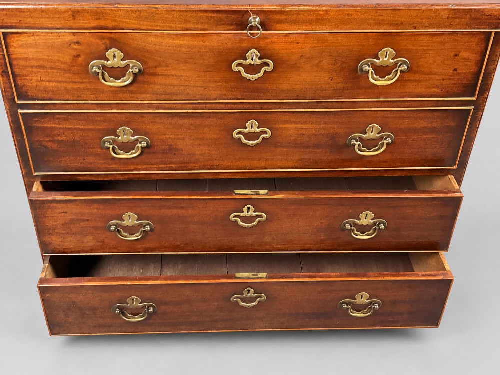 An 18th-century mahogany campaign dressing chest featuring graduated drawers with brass bail handles, side carrying loops, and bracket feet. View III