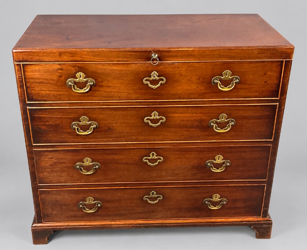An 18th-century mahogany campaign dressing chest featuring graduated drawers with brass bail handles, side carrying loops, and bracket feet. View IV