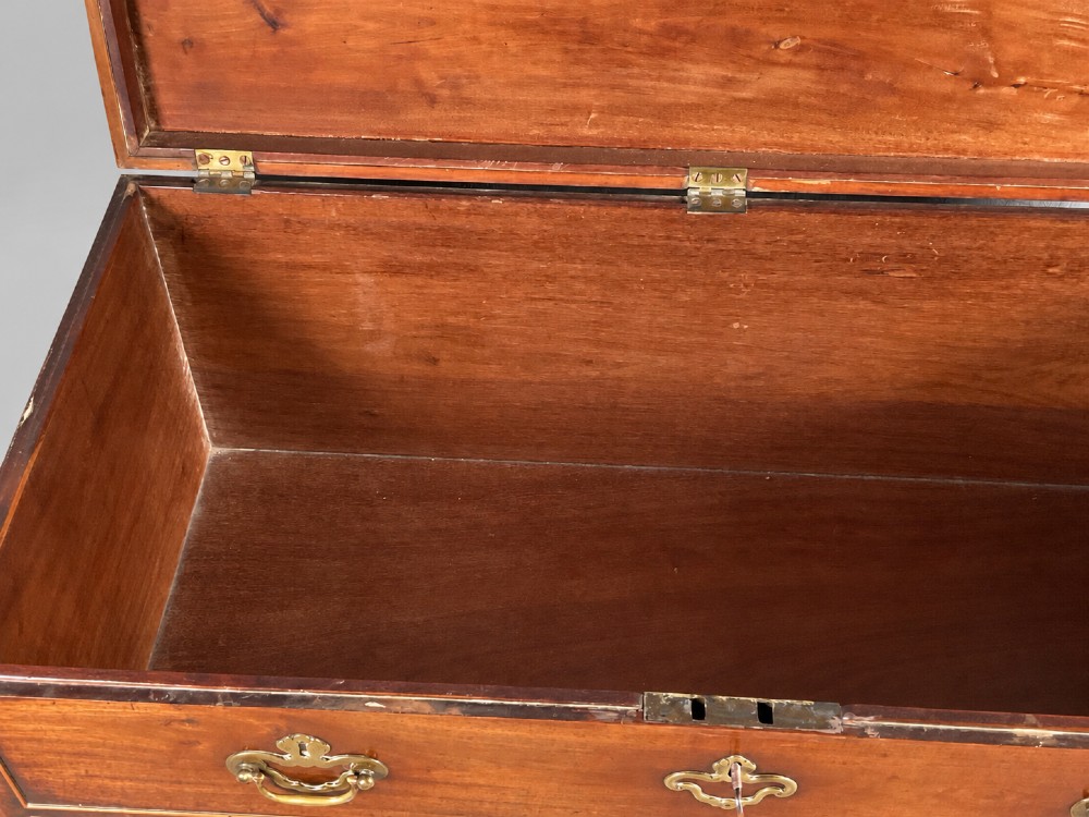 An 18th-century mahogany campaign dressing chest featuring graduated drawers with brass bail handles, side carrying loops, and bracket feet. View VI