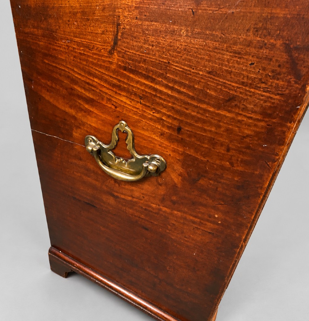An 18th-century mahogany campaign dressing chest featuring graduated drawers with brass bail handles, side carrying loops, and bracket feet. View X