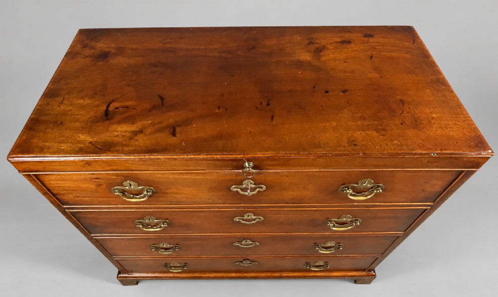 An 18th-century mahogany campaign dressing chest featuring graduated drawers with brass bail handles, side carrying loops, and bracket feet. View XIII