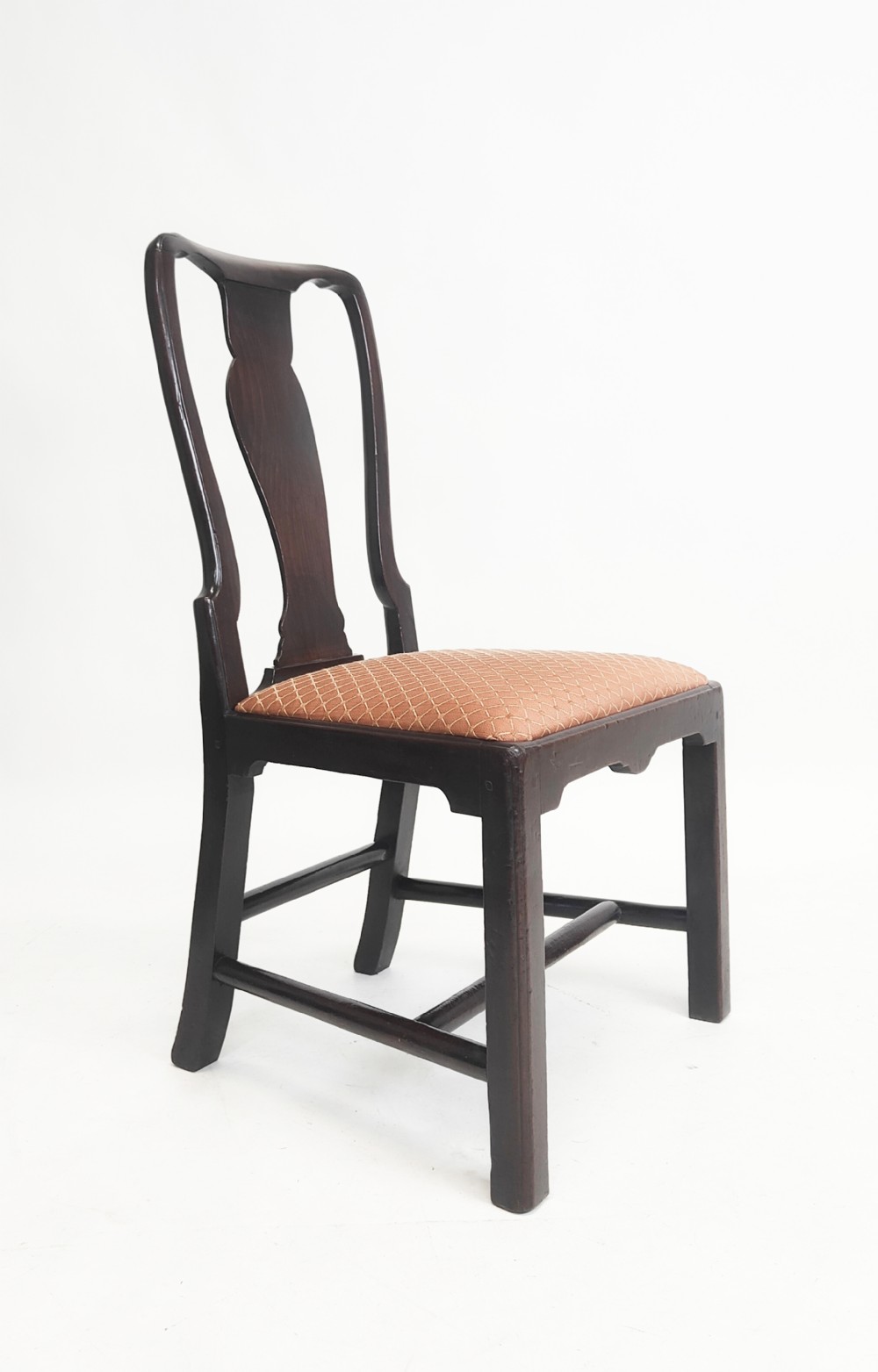 An eighteenth-century dark mahogany side chair featuring a vasiform splat back and a geometric patterned drop-in seat.