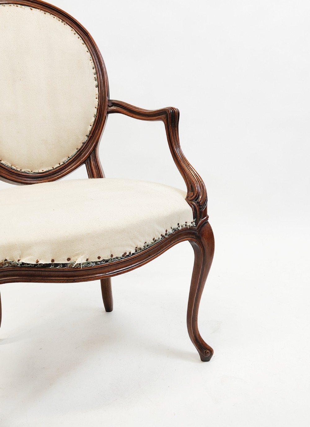 A 19th-century French open armchair featuring a carved wooden frame, medallion backrest, cabriole legs, and light cream upholstery. View IX