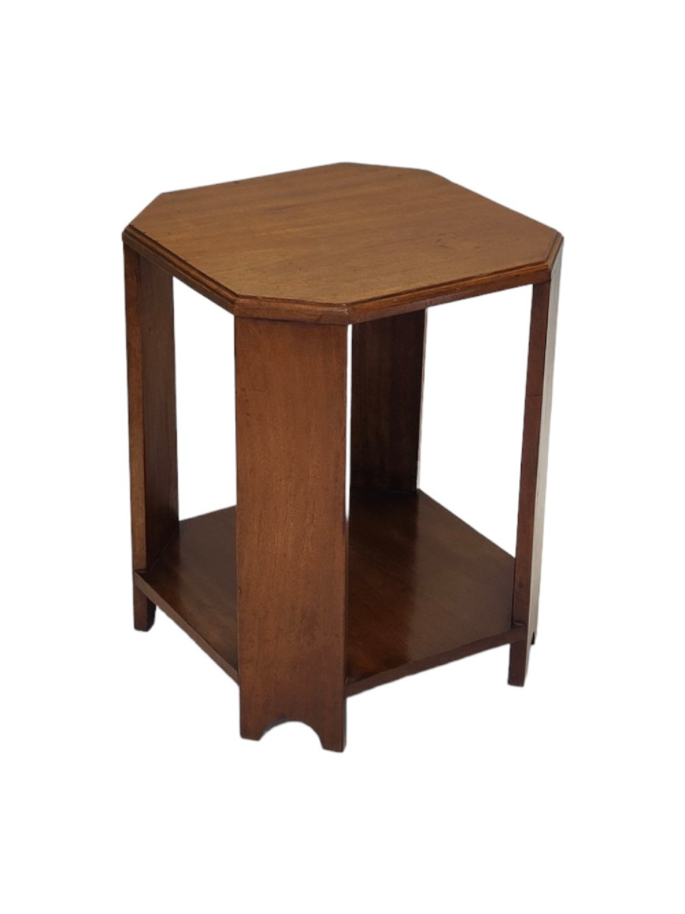 An early 20th-century warm brown walnut side table featuring an octagonal top, a lower square shelf, and broad flat legs with arched cutouts at the base.