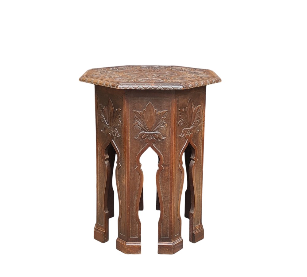 An early twentieth-century octagonal carved wooden Moorish side table with archways and foliate details.