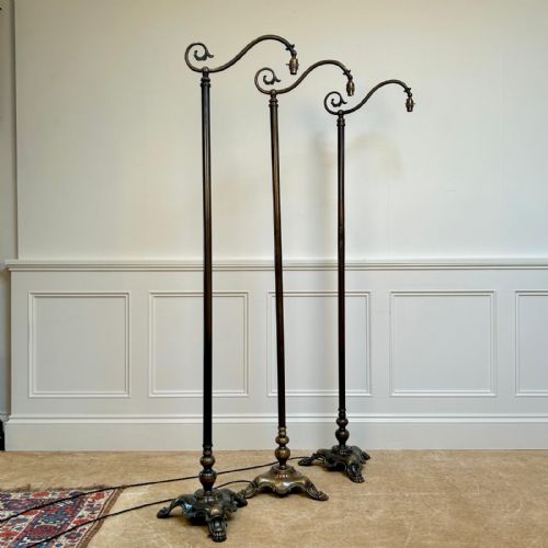 A SET OF 3 PATINATED BRASS FLOOR LAMPS