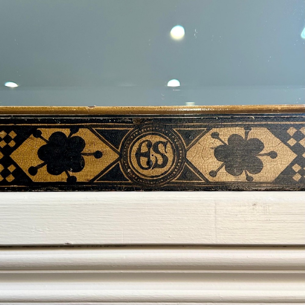 A rectangular 19th-century Italian wall mirror featuring an ebonised and gilded wooden frame decorated with geometric motifs and clover patterns. View II