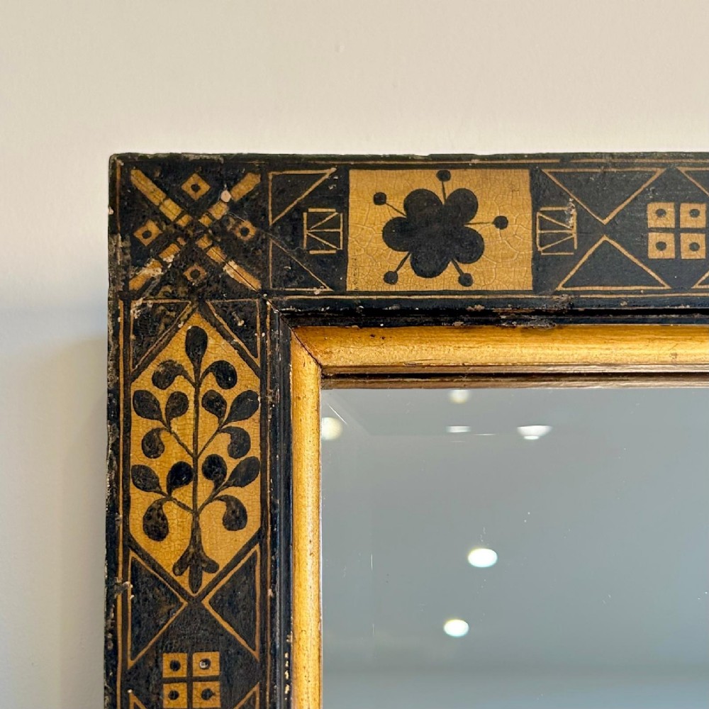 A rectangular 19th-century Italian wall mirror featuring an ebonised and gilded wooden frame decorated with geometric motifs and clover patterns. View VI