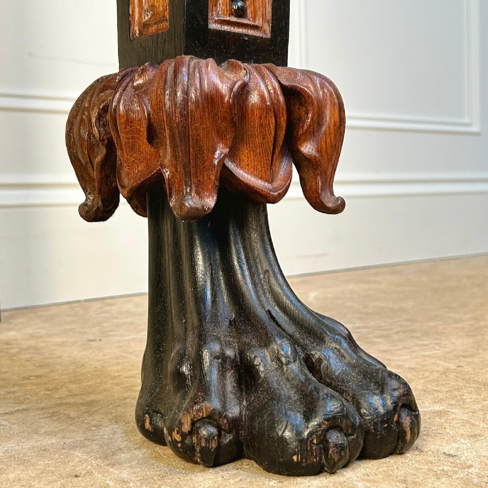 A Regency oak console table featuring a dark stone top, ebonised trim, and front legs carved with acanthus leaves and lion paw feet. View IV