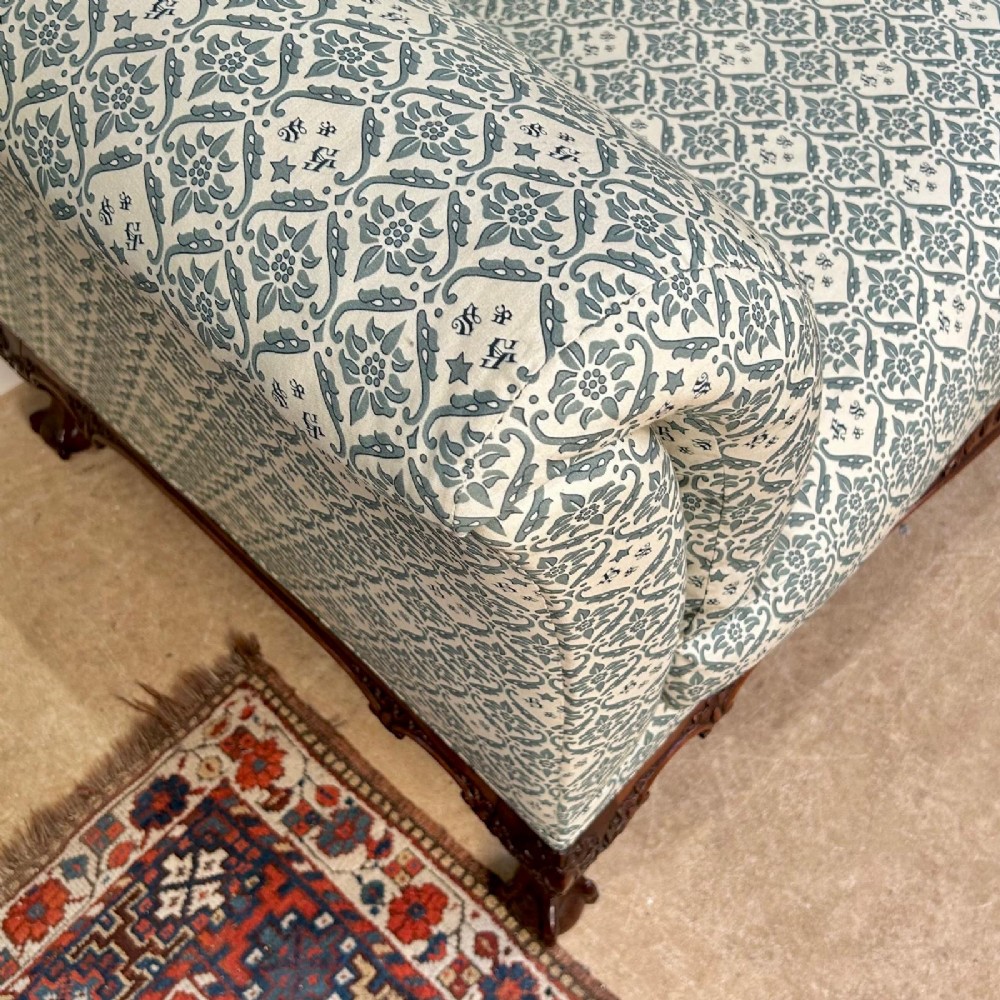 A two-seater upholstered sofa featuring sage green and cream patterned fabric with carved mahogany cabriole front legs. View III