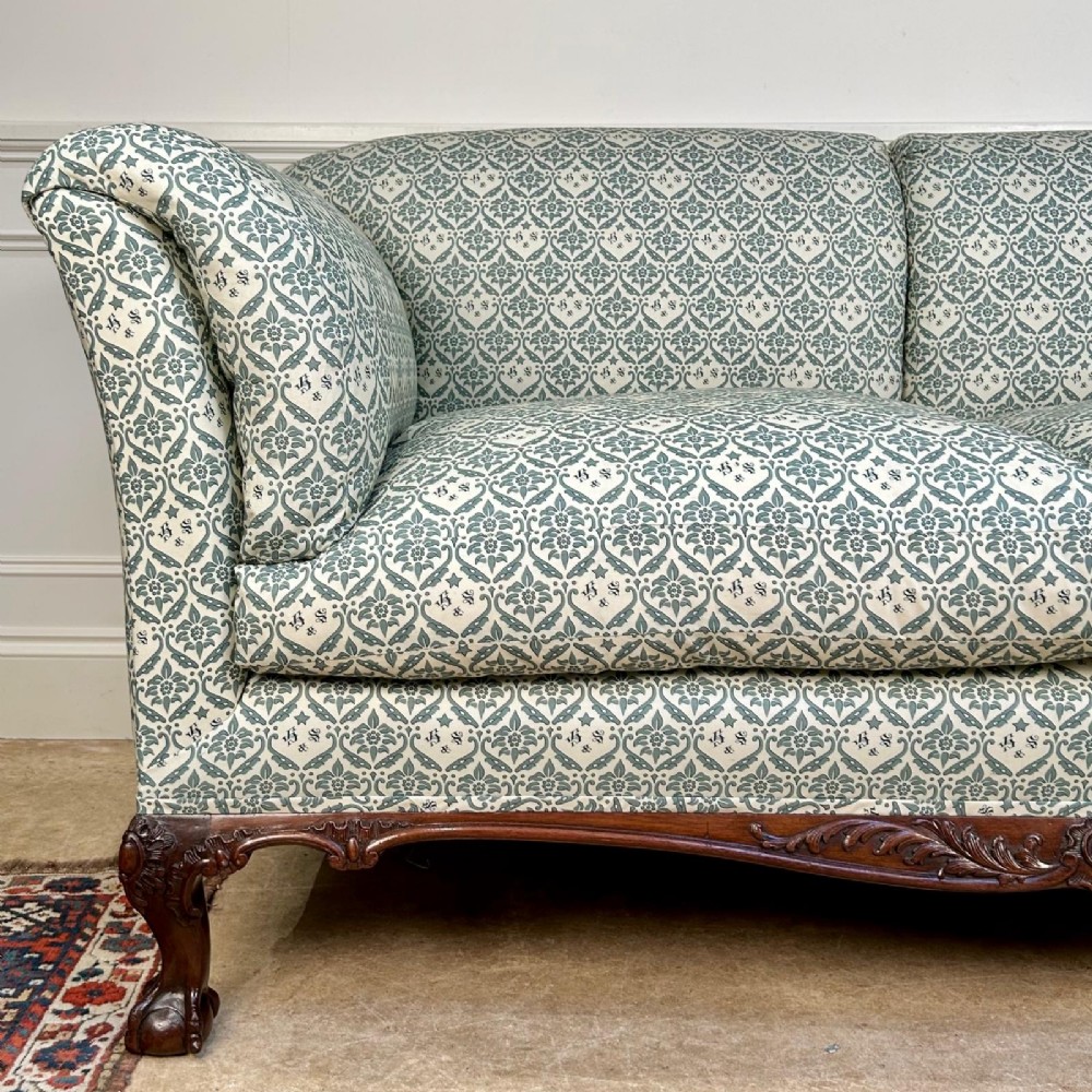 A two-seater upholstered sofa featuring sage green and cream patterned fabric with carved mahogany cabriole front legs. View IV