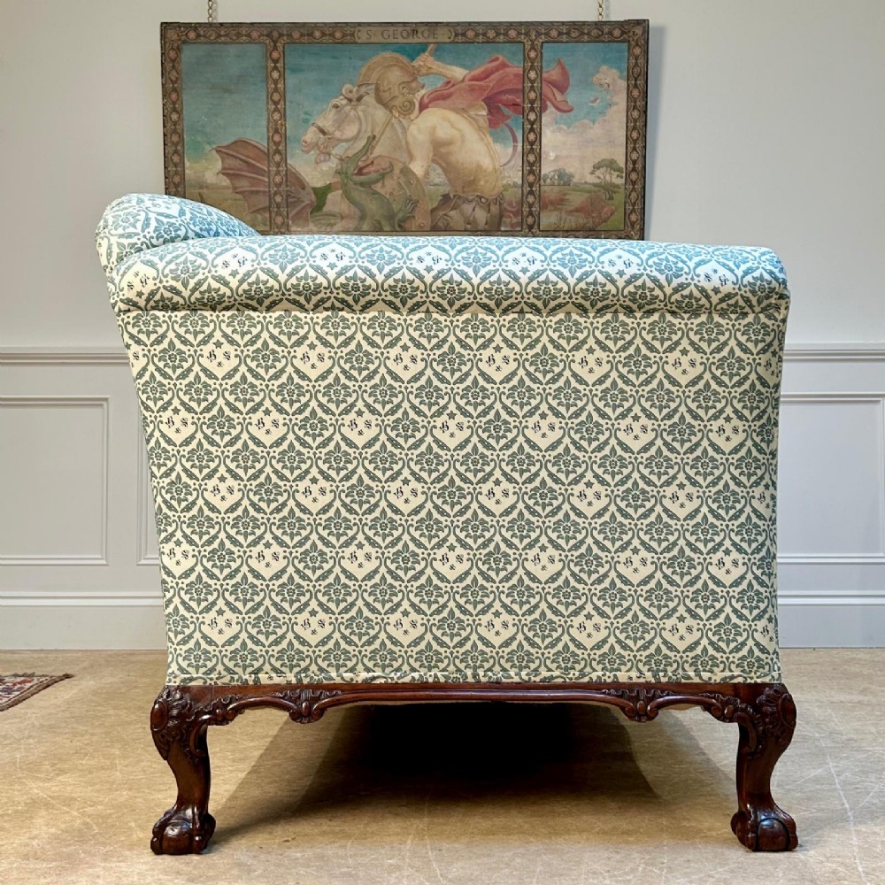 A two-seater upholstered sofa featuring sage green and cream patterned fabric with carved mahogany cabriole front legs. View V