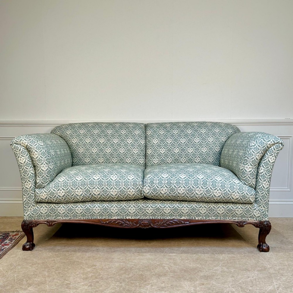 A two-seater upholstered sofa featuring sage green and cream patterned fabric with carved mahogany cabriole front legs. View VI