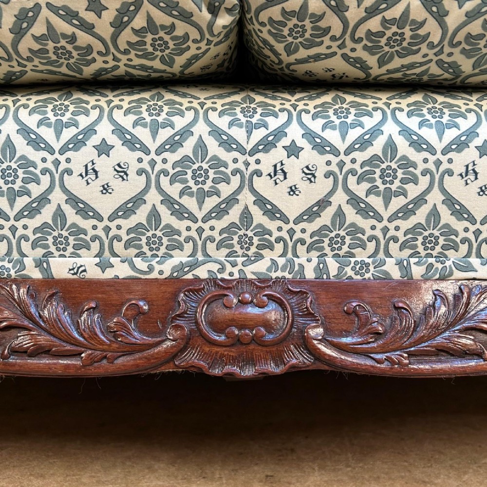 A two-seater upholstered sofa featuring sage green and cream patterned fabric with carved mahogany cabriole front legs. View VII