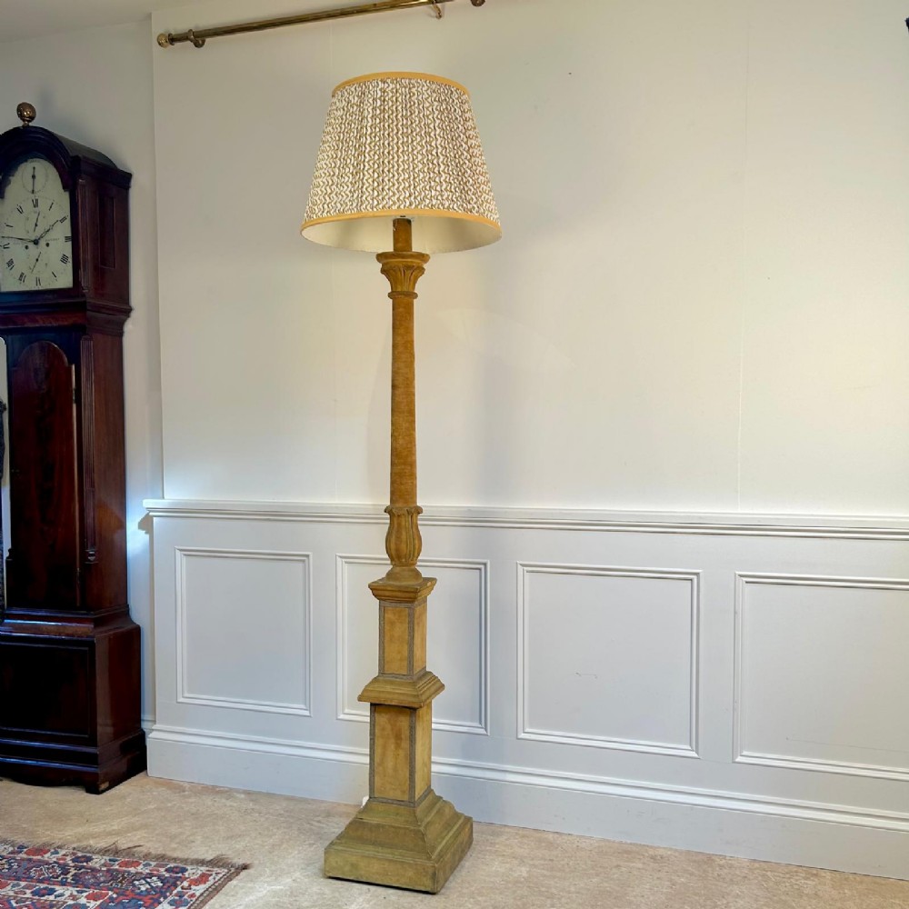 A tall 1930s Italian standard floor lamp featuring an ochre velvet-upholstered column base and a patterned fabric tapered shade.