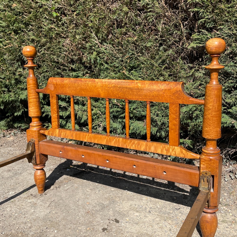 An early nineteenth-century American Federal bedstead constructed from figured tiger maple wood featuring four turned posts, cannonball finials, and a spindle headboard. View III