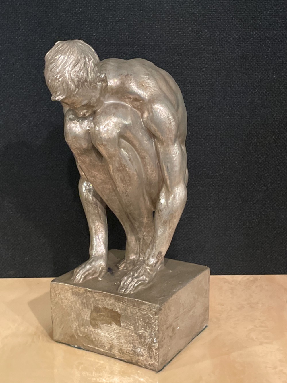 An Art Deco silvered figure of a crouching male nude View II