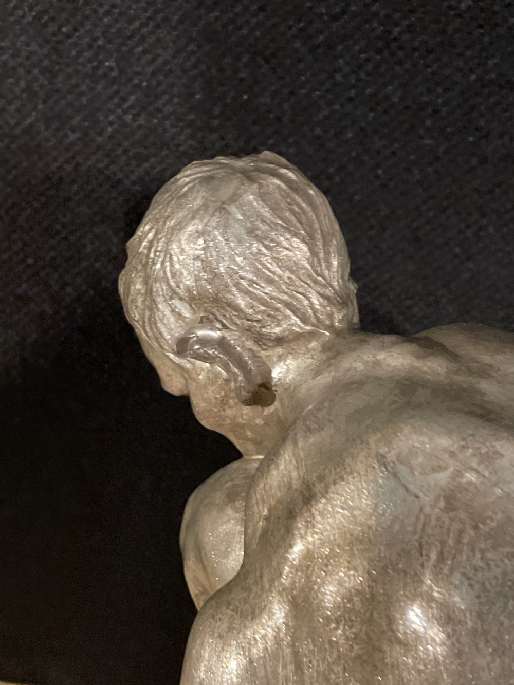 An Art Deco silvered figure of a crouching male nude View VIII